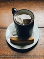 Biscotti and cup of tea served on a white plate and an old wooden table - PhotoDune Item for Sale