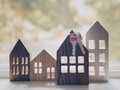 Wooden homes with cutout windows with keys hanging and a bokeh of trees behind - PhotoDune Item for Sale