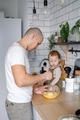 A dad and baby toddler having fun cooking at home. A young father with child spending time together. - PhotoDune Item for Sale