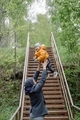 A laughing baby toddler tossed up by dad. A father plays with his child outdoors in park forest.    - PhotoDune Item for Sale