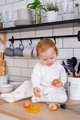A toddler making mess on the kitchen, helping to cook, broking eggs. Learning world. - PhotoDune Item for Sale