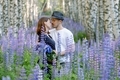 Happy couple posing hugging in purple flowers field in birch forest. Romantic nature walk in summer. - PhotoDune Item for Sale