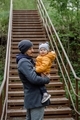 A dad holding a baby toddler walking in the forest on spring. A father and kid posing for picture. - PhotoDune Item for Sale