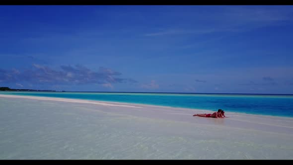 Man and lady sunbathe on exotic lagoon beach time by aqua blue sea with white sand background of the