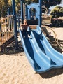 Boy sliding down a blue slide at a playground for children  #debb_a/childhood - PhotoDune Item for Sale