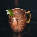 Moscow mule in a copper mug with a lime on a black table - PhotoDune Item for Sale