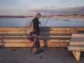 Fisherman with gear on a pier at Golden Hour - PhotoDune Item for Sale