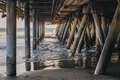 ocean waves softly crashing under a wooden pier in Santa Monica, California - PhotoDune Item for Sale
