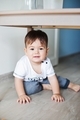 happy kid baby boy under table in new home, happy smiling baby  moving to new house, kids being kids - PhotoDune Item for Sale