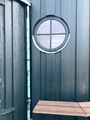 Round window, green wall, and wooden bench - PhotoDune Item for Sale