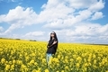 A girl in a field of yellow flowers. - PhotoDune Item for Sale