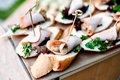 Delicious catering banquet buffet table. sandwiches with ham, vegetables, mushrooms and greenery  - PhotoDune Item for Sale