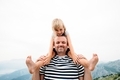 dad and daughter smiling and having fun together. daughter sitting on dad's shoulders. - PhotoDune Item for Sale
