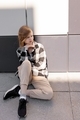 A young girl on a white-gray wall background on a sunny day. - PhotoDune Item for Sale