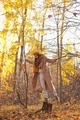 Young woman in beige coat and yellow beret walking in autumn forest in nature outdoors - PhotoDune Item for Sale