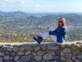 A woman sits on a stone wall,Gorgeous view of San Diego County  as seen from the top of Mt. Helix 
 - PhotoDune Item for Sale
