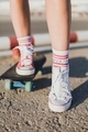 Girl on a skateboard.  Legs in sneakers close-up - PhotoDune Item for Sale