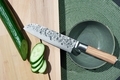 Sharp chef's knife close up on the cutting board and sliced cucumber . - PhotoDune Item for Sale
