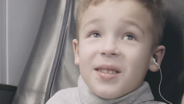 Child Watching TV During Train Journey