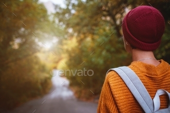 y surrounded autumn forest in mountains. Portrait of romantic hipster female, Warm autumn weather, calm scene. Wanderlust photo series.