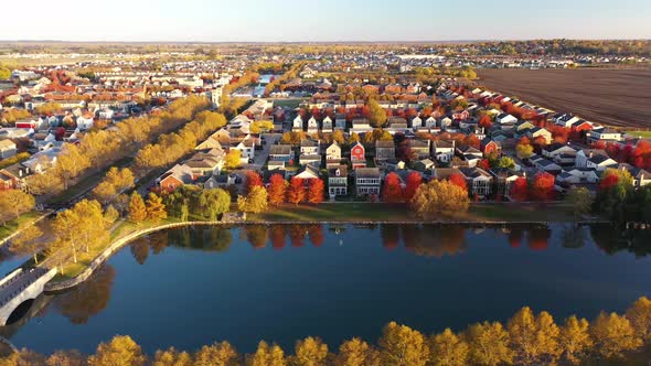 Colorful Fall Neighborhood In Suburbs Sunset Lake Drone Shot