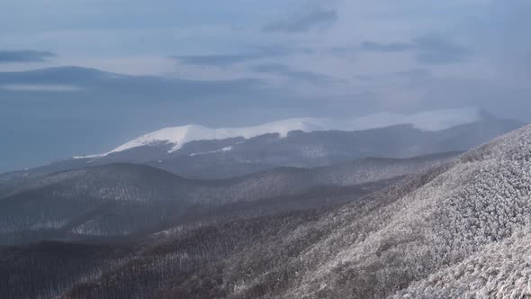 Moving mists over the snow-covered mountain slopes