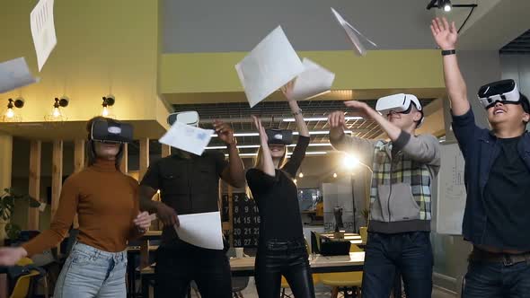 Cheerful Office Workers Group in VR Virtual Glasses Throwing Paper Documents