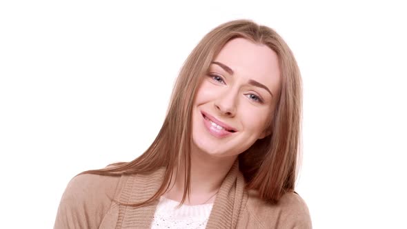 Cute Charming Caucasian Young Female Smiling at Camera with Adoration Standing on White Background