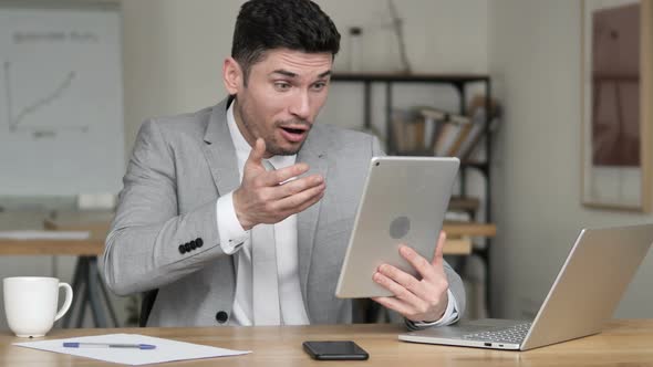 Businessman Reacting to Loss on Tablet