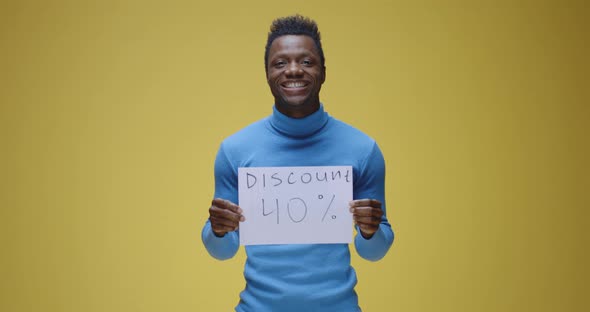 Young Man Holding Sign