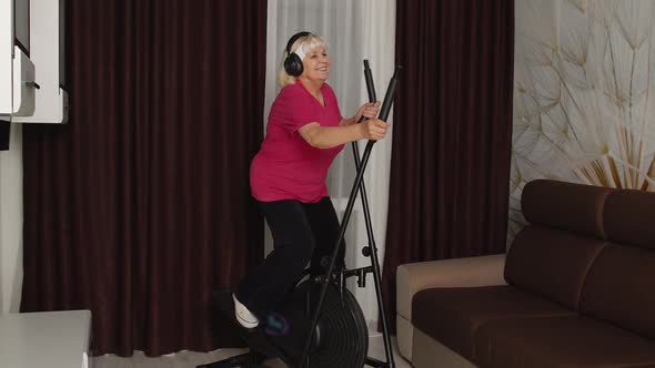 Senior Woman Using Orbitrek with Fitness Exercises in Room at Home During Coronavirus Lockdown