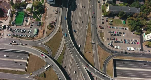 Aerial drone view of highway multi-level junction road with moving cars