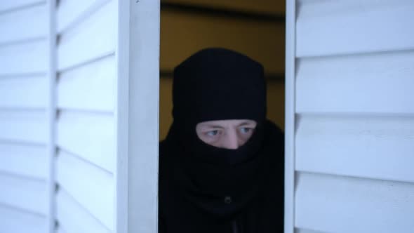 Masked Suspicious Man in Balaclava Opening Door Looking Around Stealing Private Property