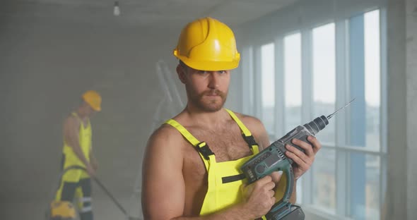 Young Handsome Male Construction Worker Posing Seductively Shirtless Holding Drilling Machine