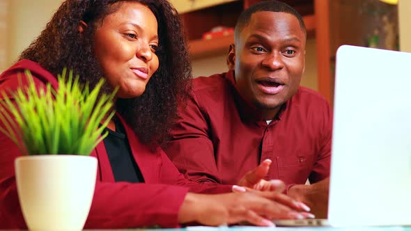 African American Woman and Man in Home Office in Living Room Start Up