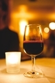 Candlelit date with red wine and romantic warm lighting - PhotoDune Item for Sale