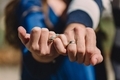 Two hands linked with wedding rings showing, couple in love, just married newlyweds in sunshine  - PhotoDune Item for Sale