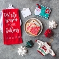 Festive Christmas flat-lay with cookies, Santa postcard, bows, tis the season to be baking towel - PhotoDune Item for Sale