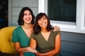 Smiling and laughing beautiful Latina mom and biracial millennial daughter family portrait - PhotoDune Item for Sale