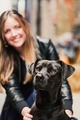 Cute black lab pit bull mix dog being held by his owner, a beautiful blond millennial woman - PhotoDune Item for Sale