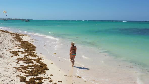 Aerial View From Drone on Caribbean Sea Beach with Woman Walking Along Shore