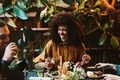 Happy laughing Young black woman at dinner table   - PhotoDune Item for Sale