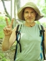 Happy senior man shows victory sign with hand after endurance hike in the forest  - PhotoDune Item for Sale