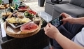 Hands holding mobile phone taking photos of colorful food outdoors - PhotoDune Item for Sale