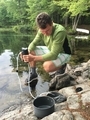 Man is filtering water from the lake for 
human consumption. Camping off the grid 
in wilderness  - PhotoDune Item for Sale