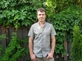 Man in plain shirt outdoor with greenery in background  - PhotoDune Item for Sale