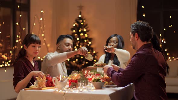 Happy Friends Having Christmas Dinner at Home