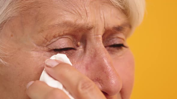 Close Up of Sad Vulnerable Old Woman Wiping Her Tears