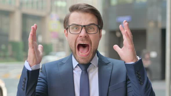 Portrait of Attractive Businessman Screaming, Shouting