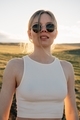 portrait of beautiful woman walking on field at sunset  - PhotoDune Item for Sale